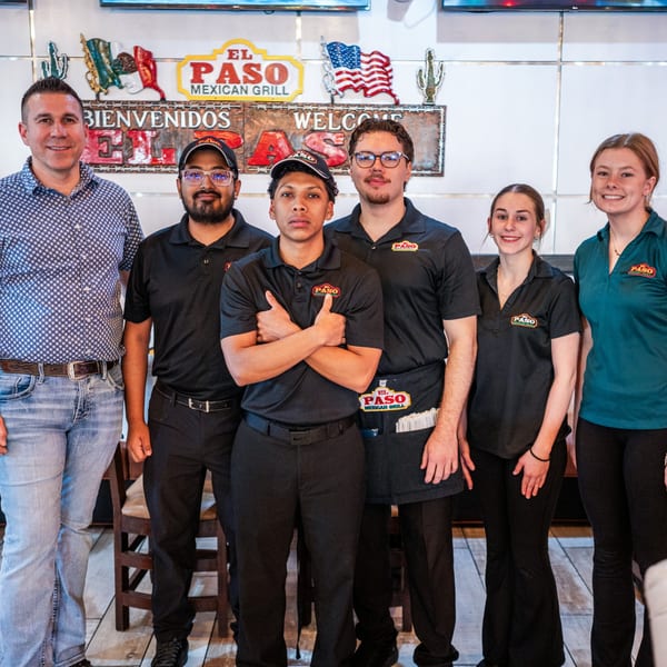 Six El Paso Mexican Grill staff members, including men and women, standing together and smiling.